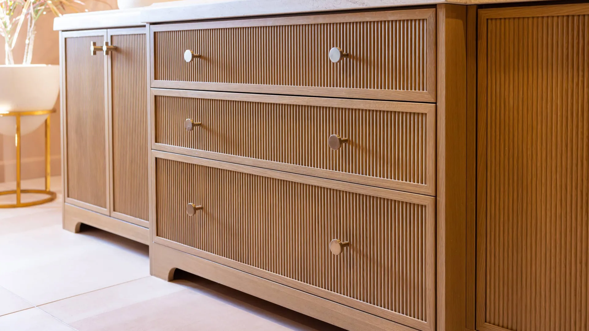 Peterson Cabinet Works reeded vanity, Capitol Reef remodel Custom vanity with reeded wood drawer fronts, reeded doors and brass knobs, built by Peterson Cabinet Works